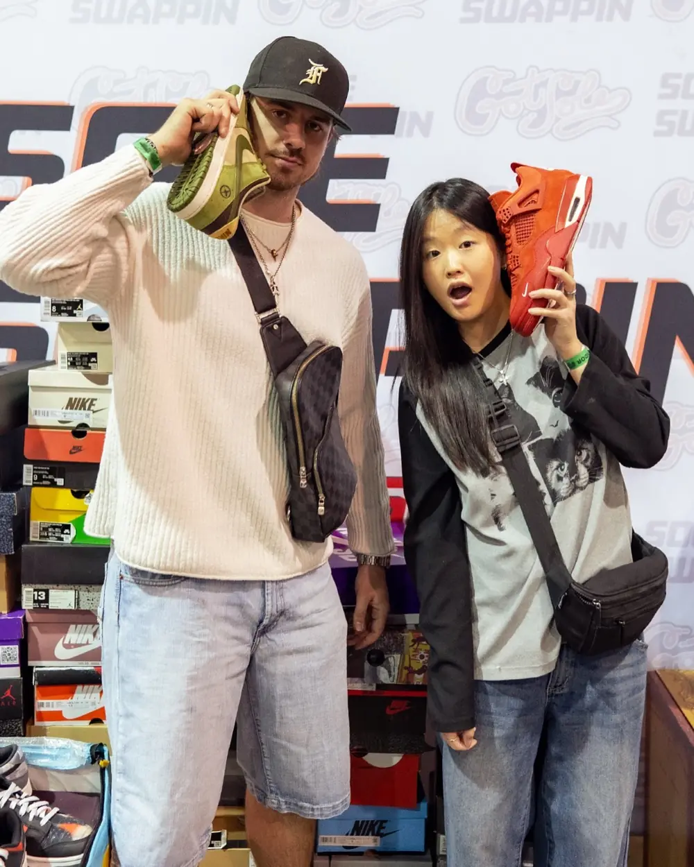 Bo holding a pair up to his ear at a sneaker convention